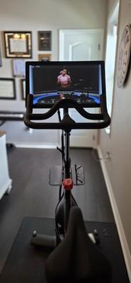 Peloton Bike with mat, bottle cage, weight holder and weights